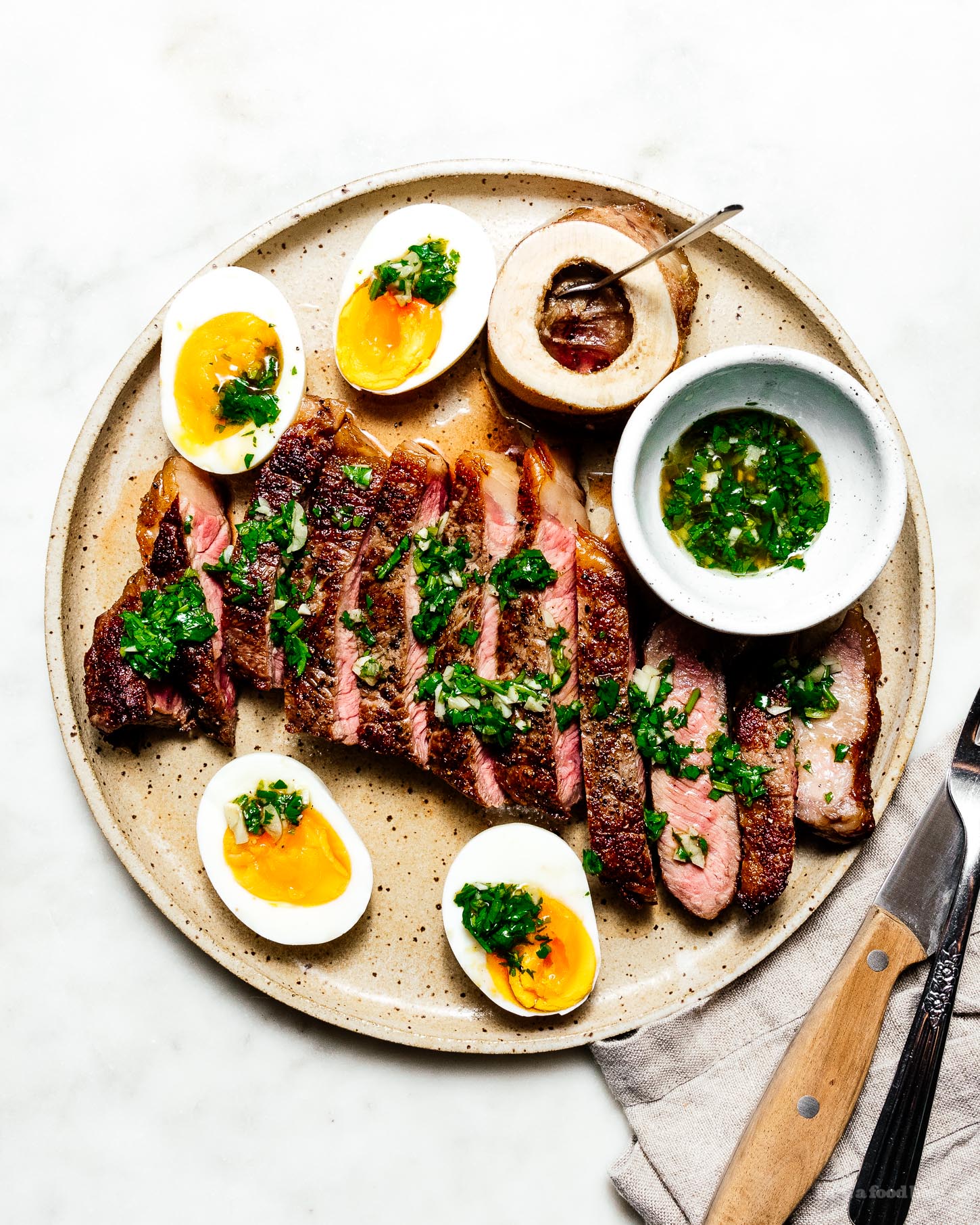 Steak with Japanese chimichurri, roasted bone marrow, and jammy eggs