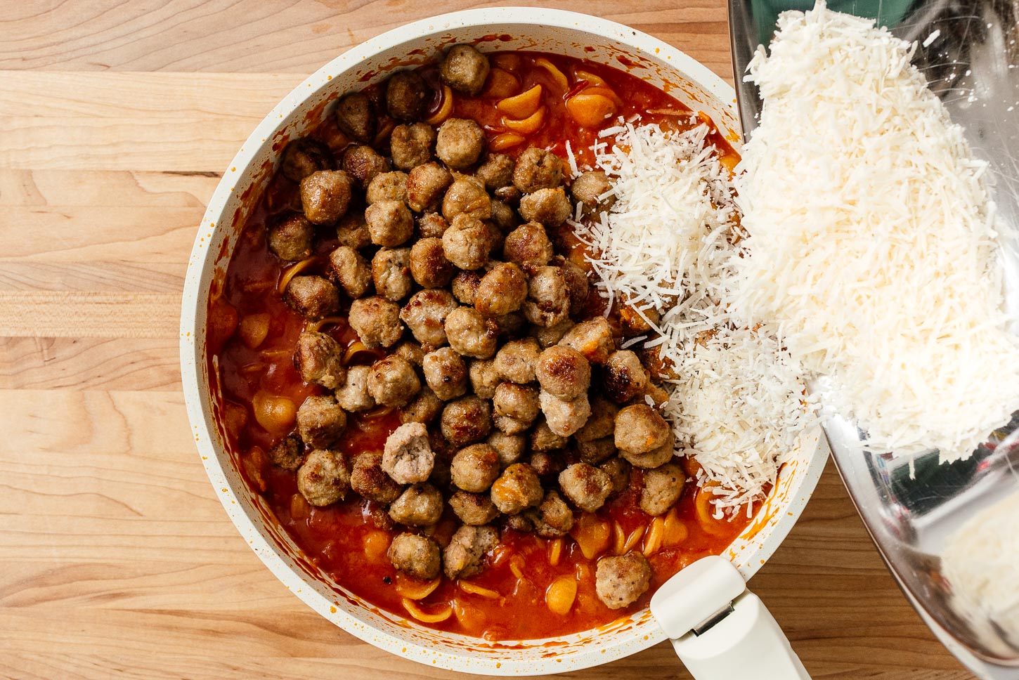 adding cheese to mini meatball pasta | www.iamafoodblog.com