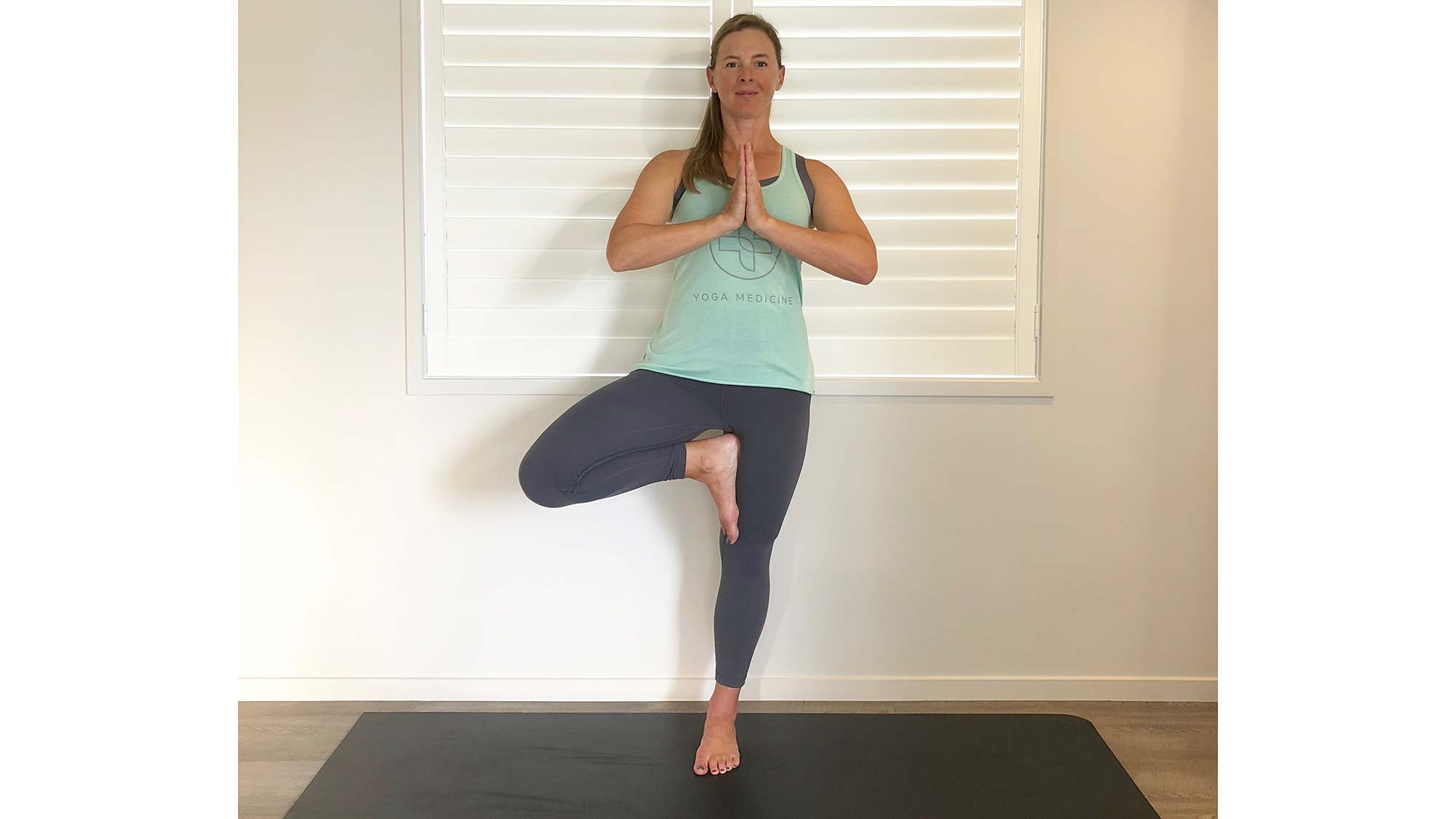 woman in balance pose on one leg